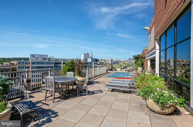 a view of roof deck with patio and garden