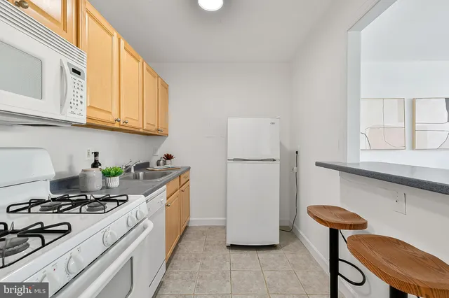 a kitchen with stainless steel appliances a stove a refrigerator and a cabinets