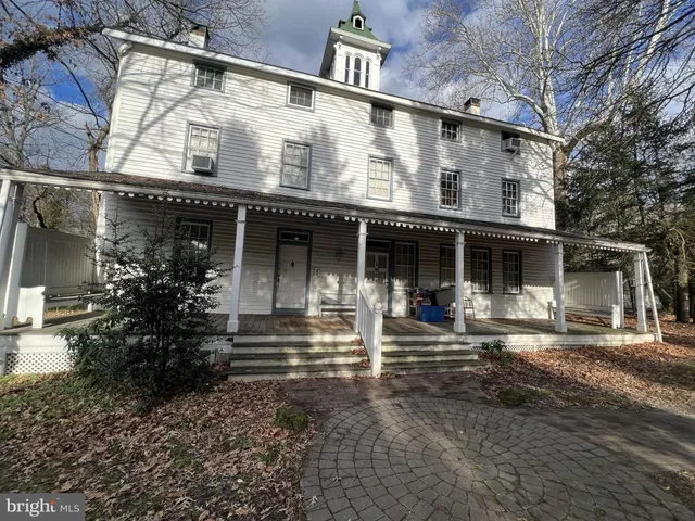 a front view of a house with sitting area