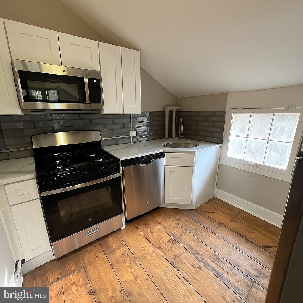 1 Breakneck Road, Unit 6 Medford, NJ 08055 - Photo 3 of 20 a kitchen with stainless steel appliances a stove a microwave and a sink