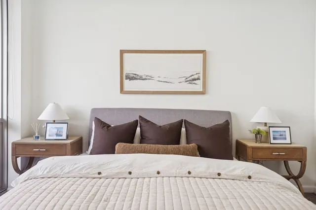 a bathroom with double vanity sink a mirror and a toilet
