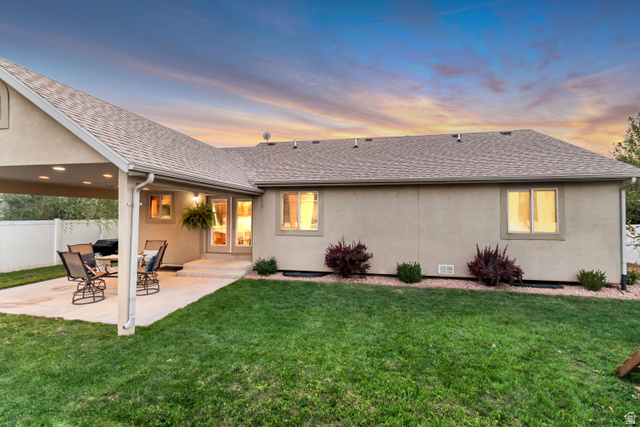 356 North 230 West Payson, UT 84651 - Photo 35 of 45 Spacious backyard featuring a covered patio with recessed lighting, a concrete patio surface, a manicured lawn, and mature landscaping