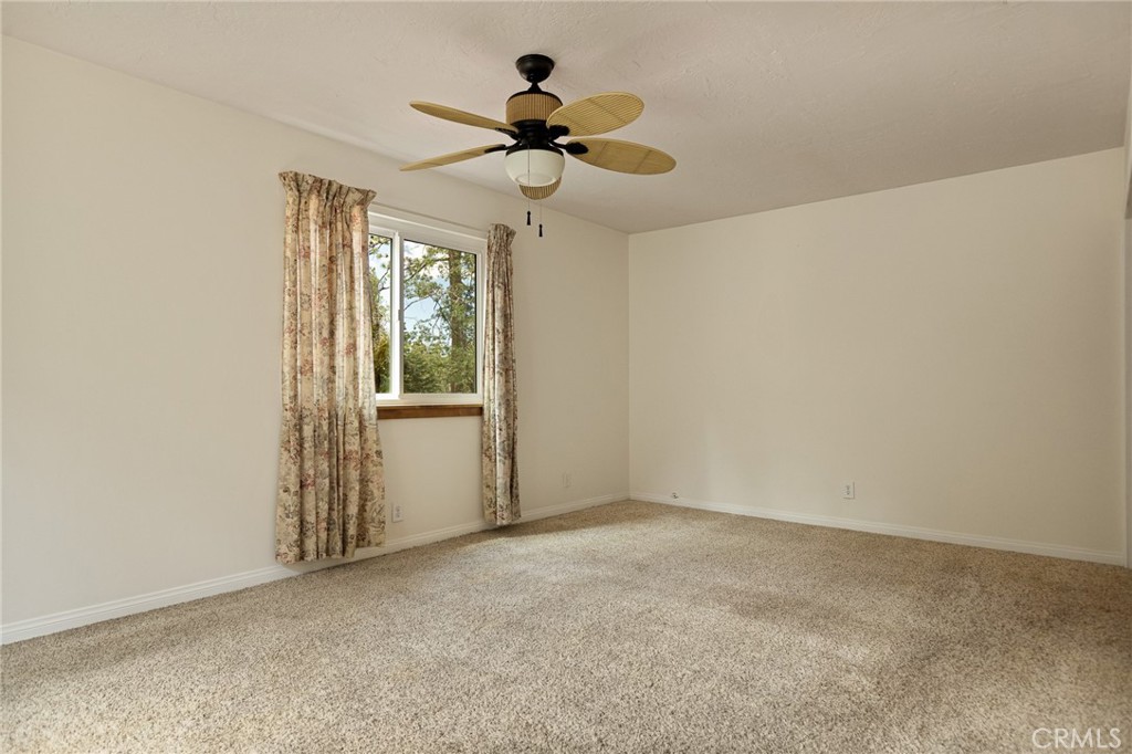 33159 Ridge Drive Running Springs, CA 92382 - Photo 11 of 24 a view of room with a ceiling fan and window