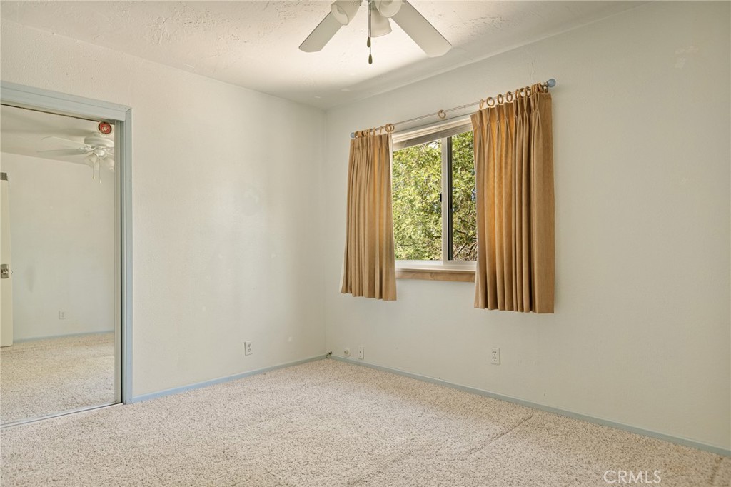 33159 Ridge Drive Running Springs, CA 92382 - Photo 14 of 24 an empty room with a window