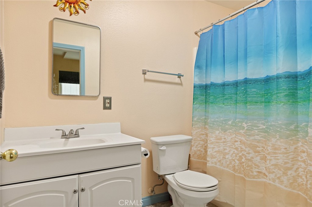33159 Ridge Drive Running Springs, CA 92382 - Photo 18 of 24 a bathroom with a sink a toilet and shower