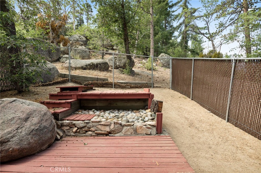 33159 Ridge Drive Running Springs, CA 92382 - Photo 19 of 24 a view of a backyard with sitting area