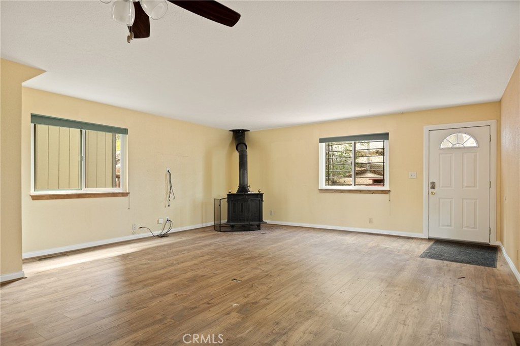 33159 Ridge Drive Running Springs, CA 92382 - Photo 5 of 24 an empty room with windows and closet