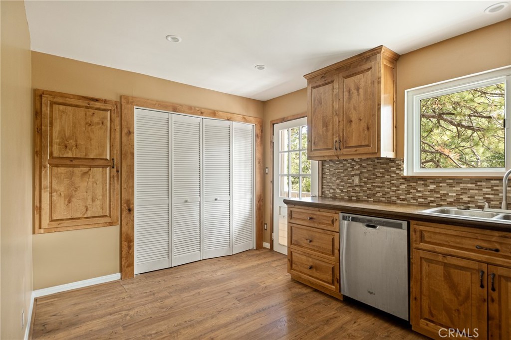 33159 Ridge Drive Running Springs, CA 92382 - Photo 8 of 24 a kitchen with stainless steel appliances granite countertop cabinets and wooden floor