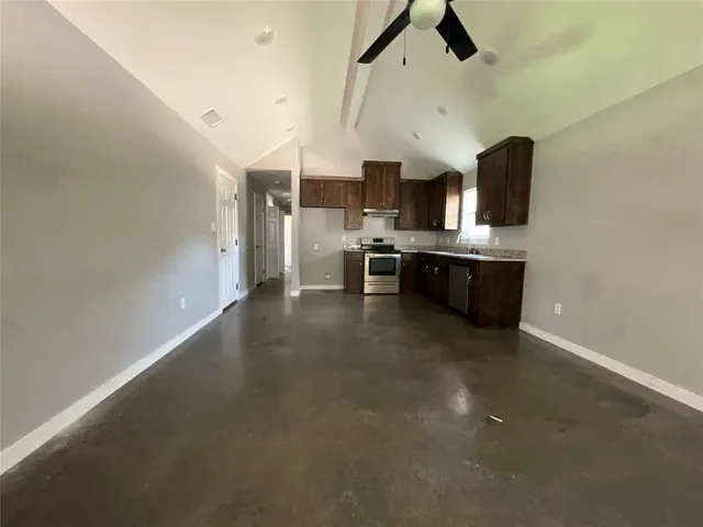 a large kitchen with a stove and a refrigerator