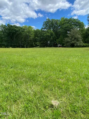 a view of a garden with a building in the background