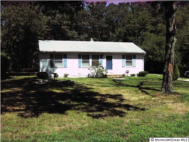 a front view of house with yard and trees