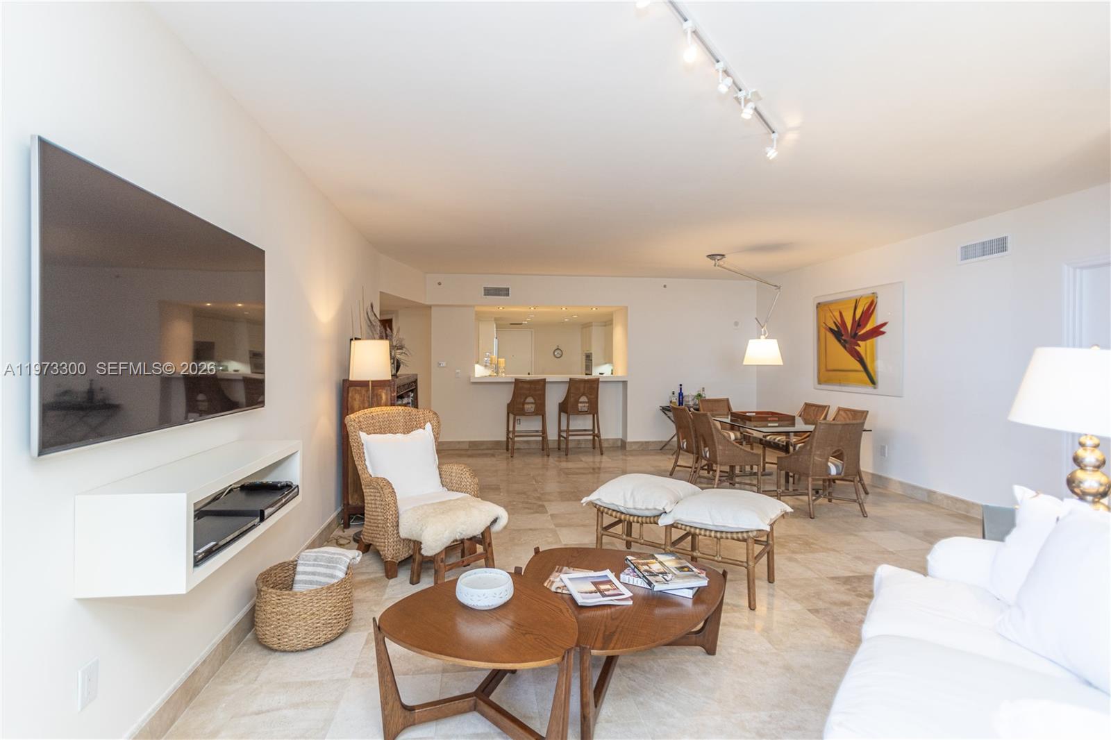 9559 Collins Avenue, Unit S7D Surfside, FL 33154 - Photo 15 of 59 a living room with furniture and a flat screen tv