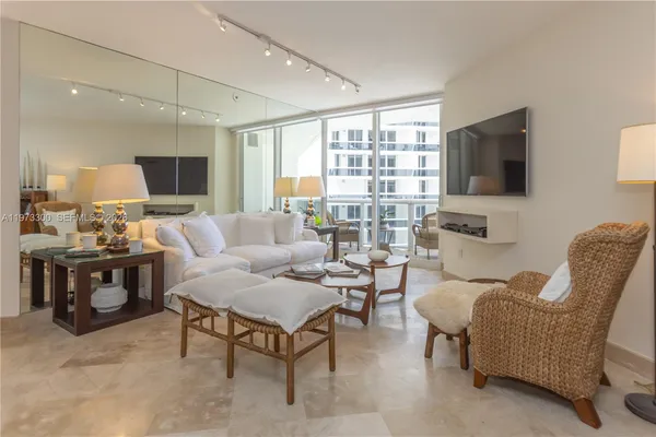 a living room with furniture a flat screen tv and a large window