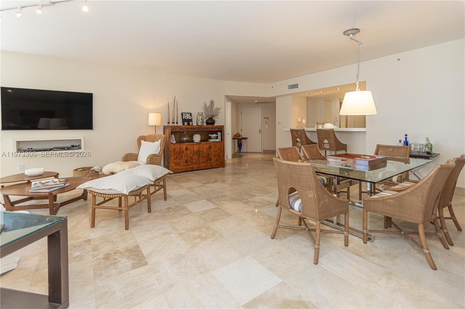 9559 Collins Avenue, Unit S7D Surfside, FL 33154 - Photo 17 of 59 a living room with furniture and a flat screen tv