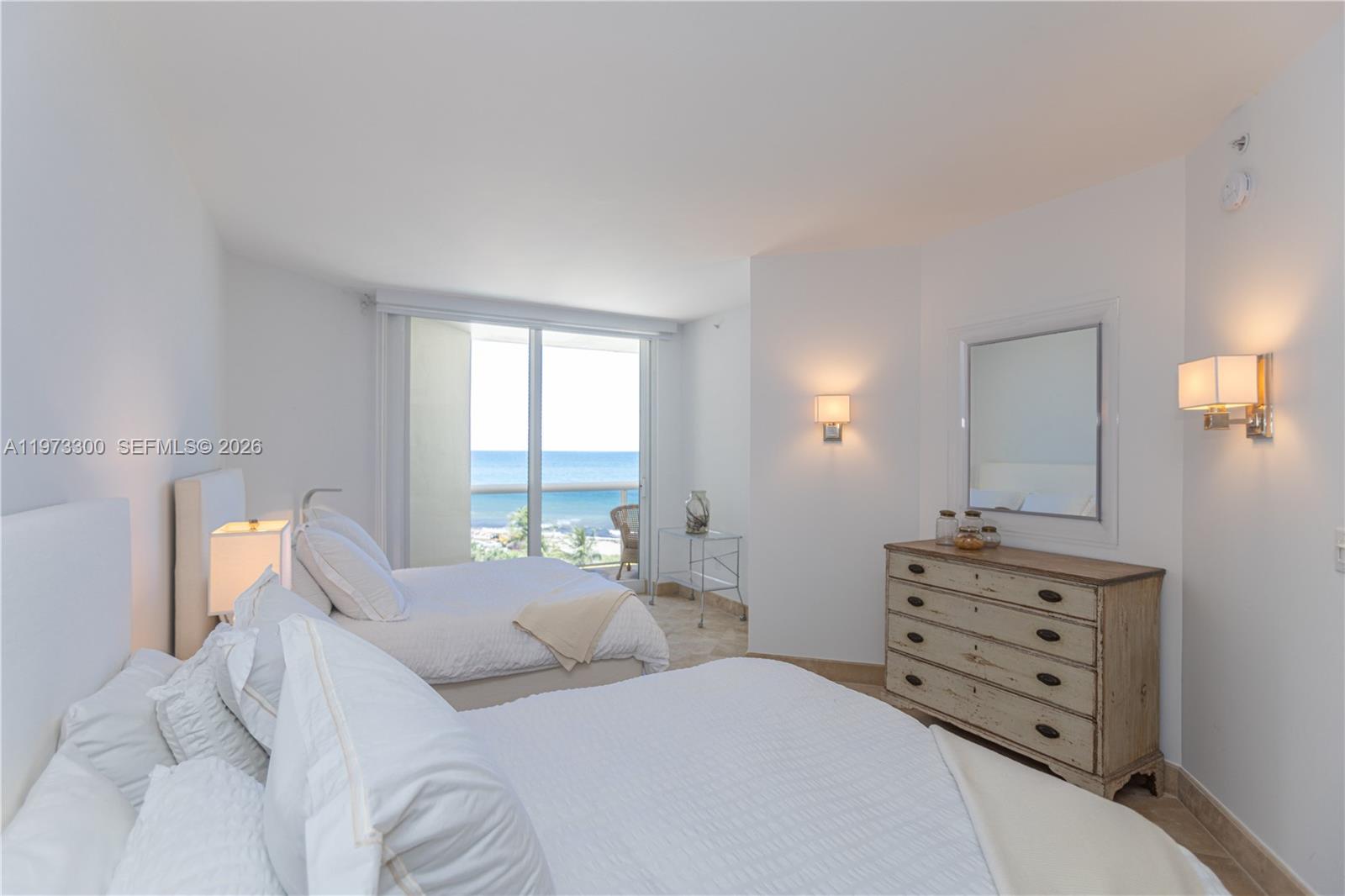 9559 Collins Avenue, Unit S7D Surfside, FL 33154 - Photo 33 of 59 a bedroom with a bed and a dresser