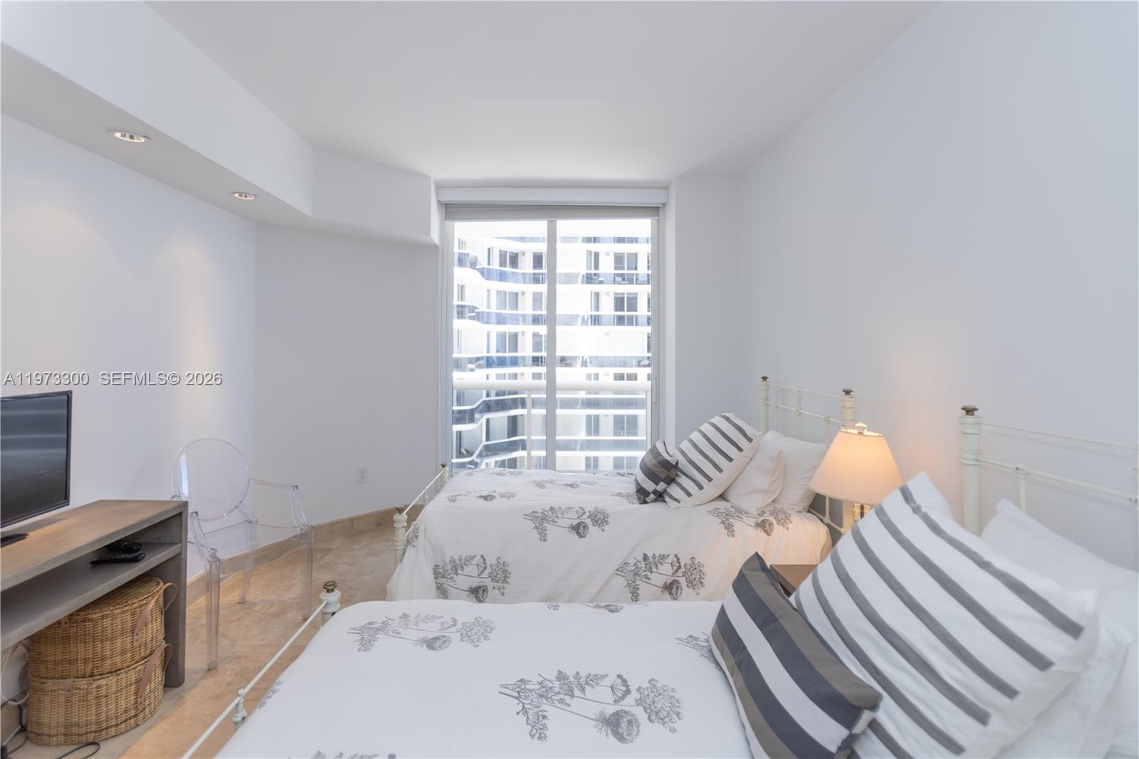 9559 Collins Avenue, Unit S7D Surfside, FL 33154 - Photo 37 of 59 a bedroom with a bed and a window