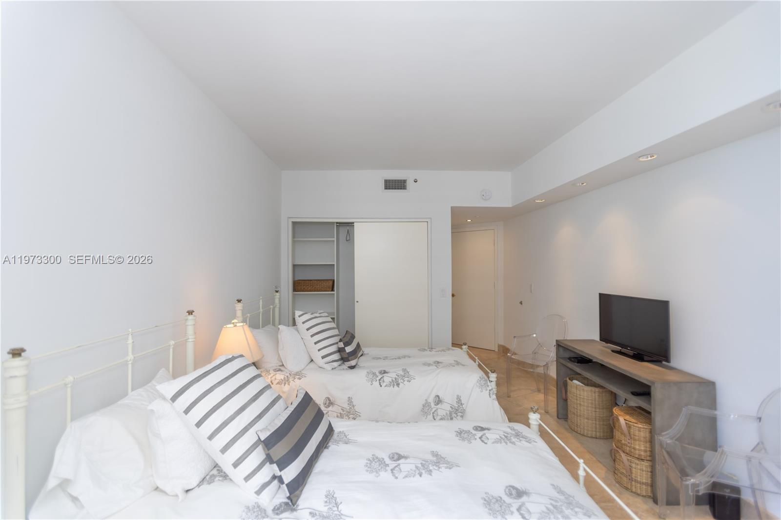 9559 Collins Avenue, Unit S7D Surfside, FL 33154 - Photo 39 of 59 a bedroom with a bed and a television in it