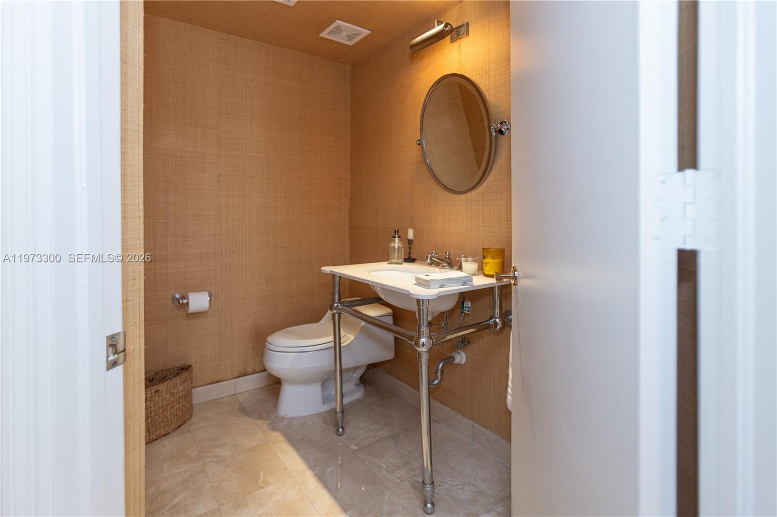 9559 Collins Avenue, Unit S7D Surfside, FL 33154 - Photo 40 of 59 a bathroom with a toilet sink and mirror