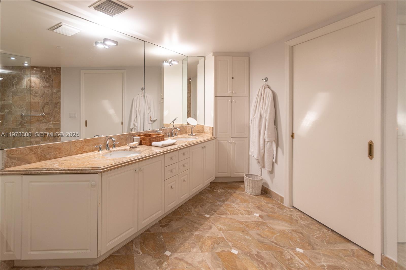 9559 Collins Avenue, Unit S7D Surfside, FL 33154 - Photo 41 of 59 a spacious bathroom with a double vanity sink and a mirror
