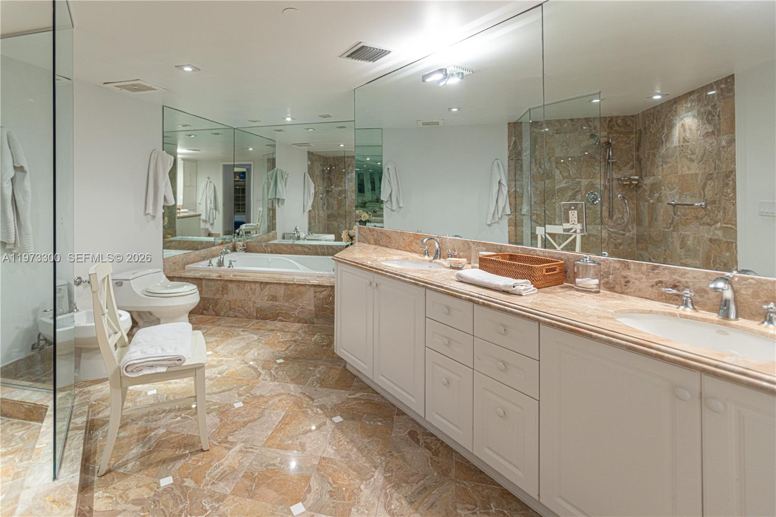 9559 Collins Avenue, Unit S7D Surfside, FL 33154 - Photo 43 of 59 a spacious bathroom with a mirror sink and toilet