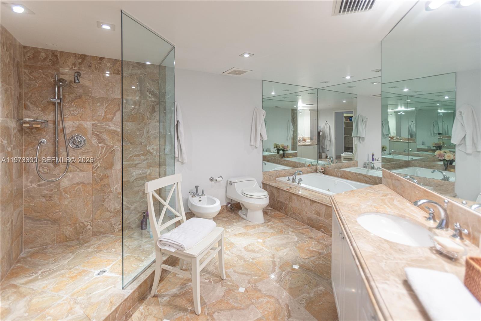 9559 Collins Avenue, Unit S7D Surfside, FL 33154 - Photo 44 of 59 a bathroom with a granite countertop sink mirror and shower