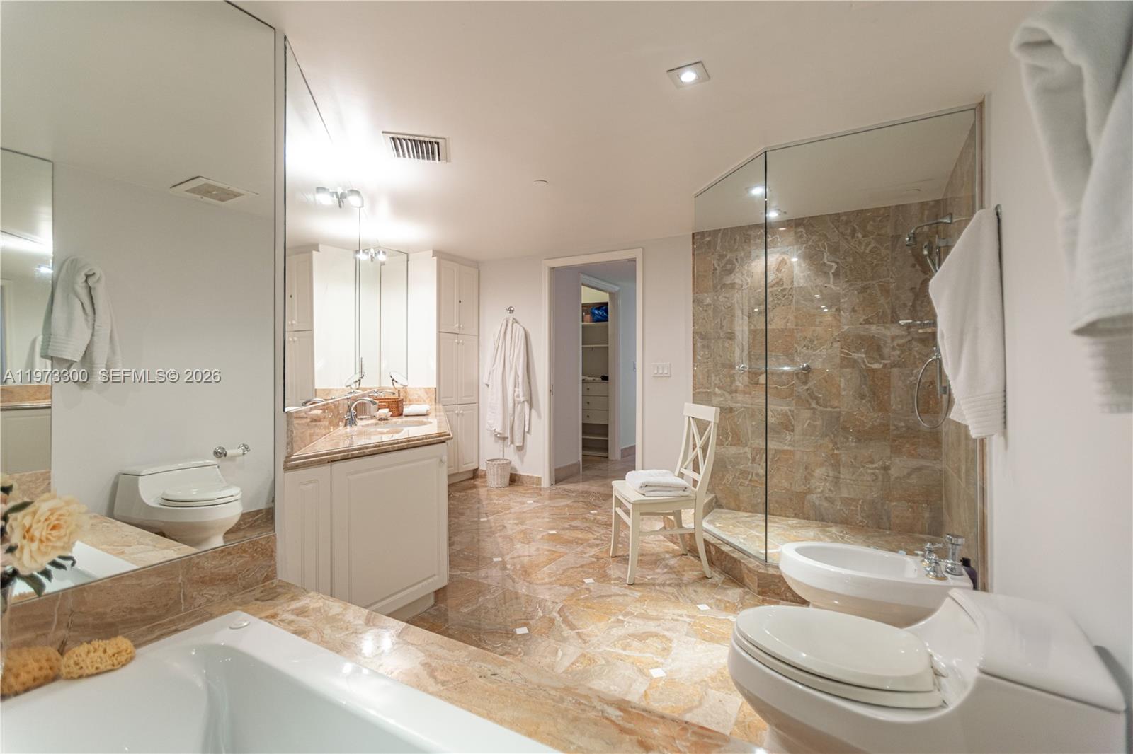 9559 Collins Avenue, Unit S7D Surfside, FL 33154 - Photo 45 of 59 a bathroom with a granite countertop sink toilet and shower