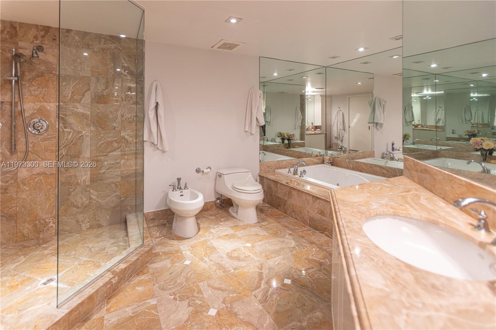 9559 Collins Avenue, Unit S7D Surfside, FL 33154 - Photo 47 of 59 a bathroom with a granite countertop sink mirror and toilet