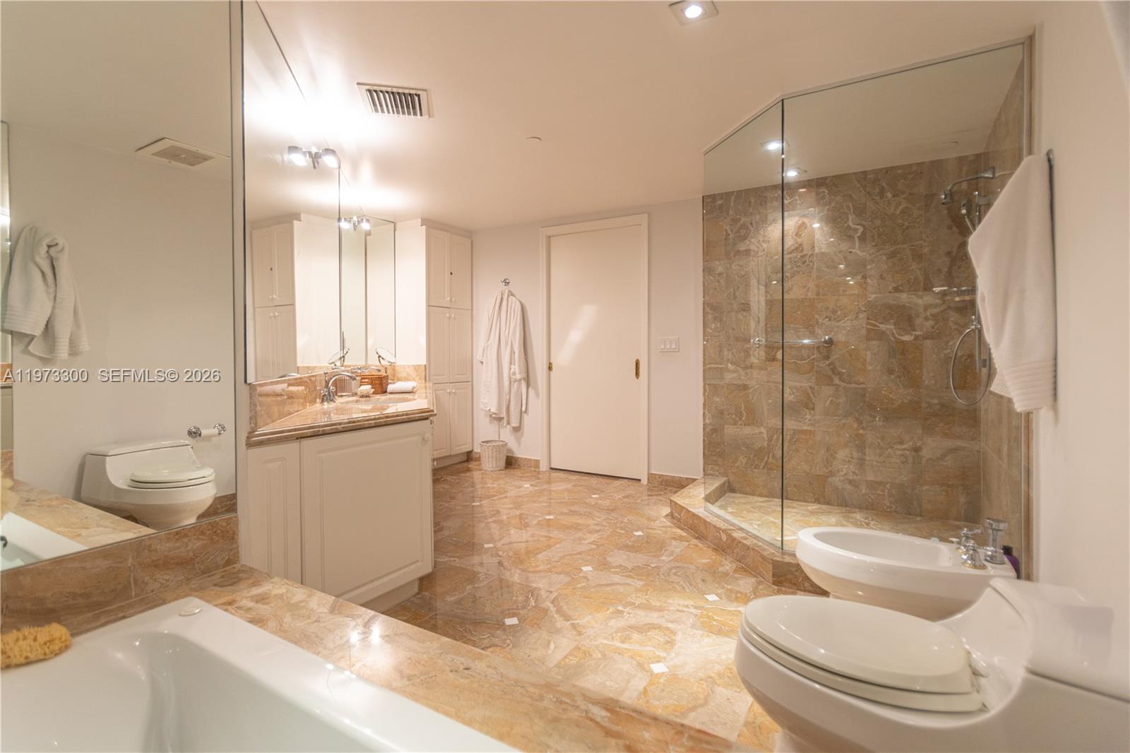 9559 Collins Avenue, Unit S7D Surfside, FL 33154 - Photo 48 of 59 a bathroom with a sink a toilet and shower