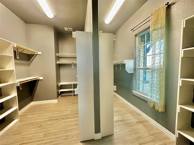 a spacious bathroom with a granite countertop sink and a mirror