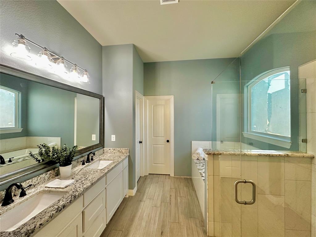 107 Rock Salt Court Springtown, TX 76082 - Photo 12 of 22 a spacious bathroom with a granite countertop sink and a mirror