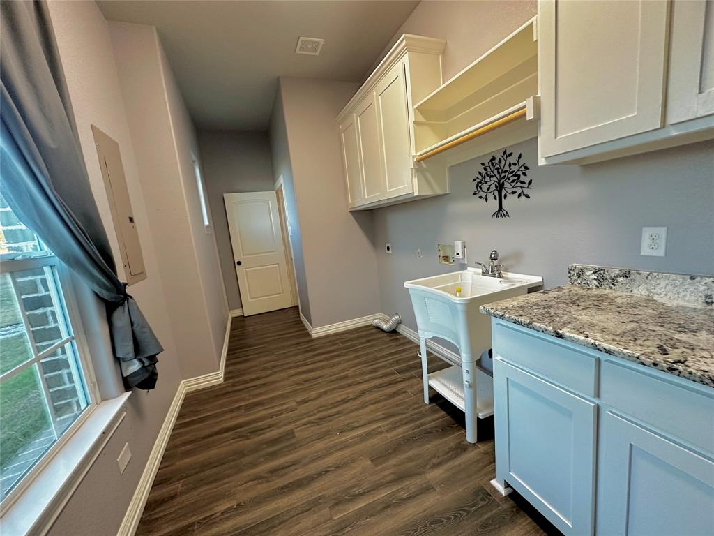 107 Rock Salt Court Springtown, TX 76082 - Photo 13 of 22 a kitchen with a sink and cabinets