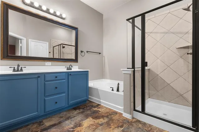 a bathroom with a tub sink and mirror