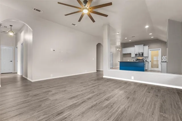 a view of a kitchen with a sink and wooden floor