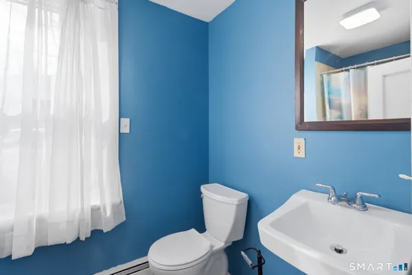 a white toilet sitting next to a white sink