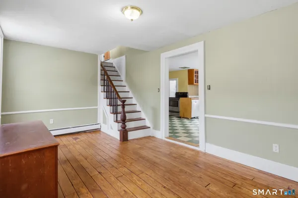 a view of wooden floor and windows in a room