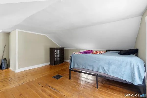 a spacious bedroom with a bed and a table