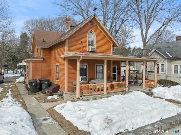 a view of a house with a yard covered in snow