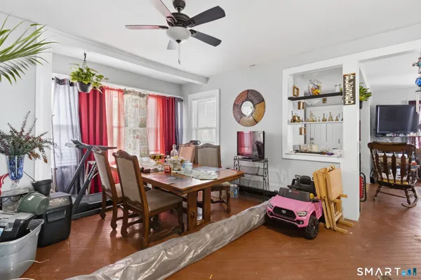 a living room with furniture a window and a flat screen tv