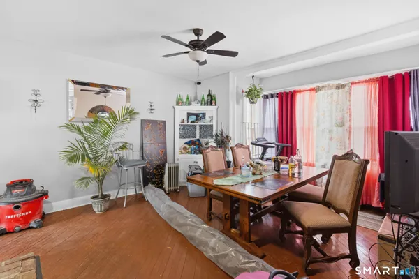a dining room with furniture and a window