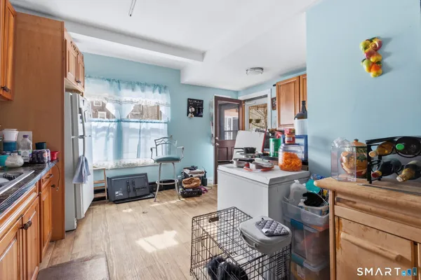 a view of a workspace with furniture and a window