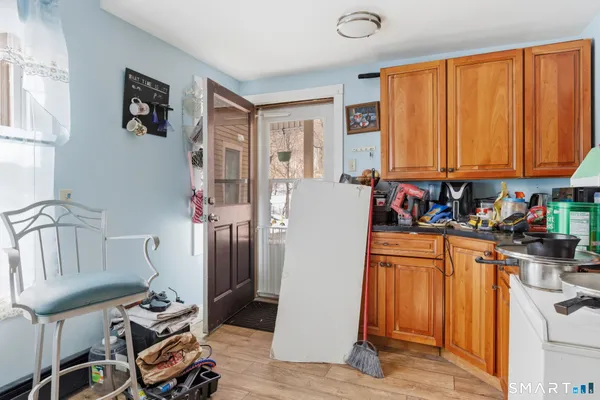 a view of a kitchen with fridge and workspace