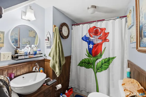 a bathroom with a sink mirror and vanity