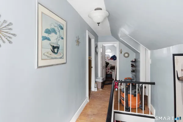 a view of a hallway with paintings on the wall