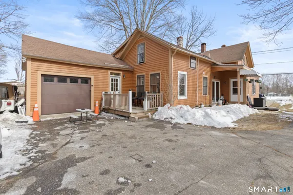 a front view of a house with a road