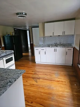 a kitchen with stainless steel appliances granite countertop a sink stove and cabinets