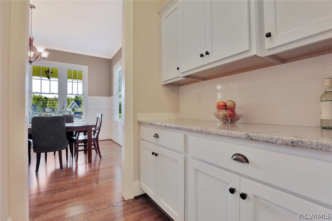 16106 Alsdell Road Midlothian, VA 23112 - Photo 14 of 46 a kitchen with white cabinets and wooden floor