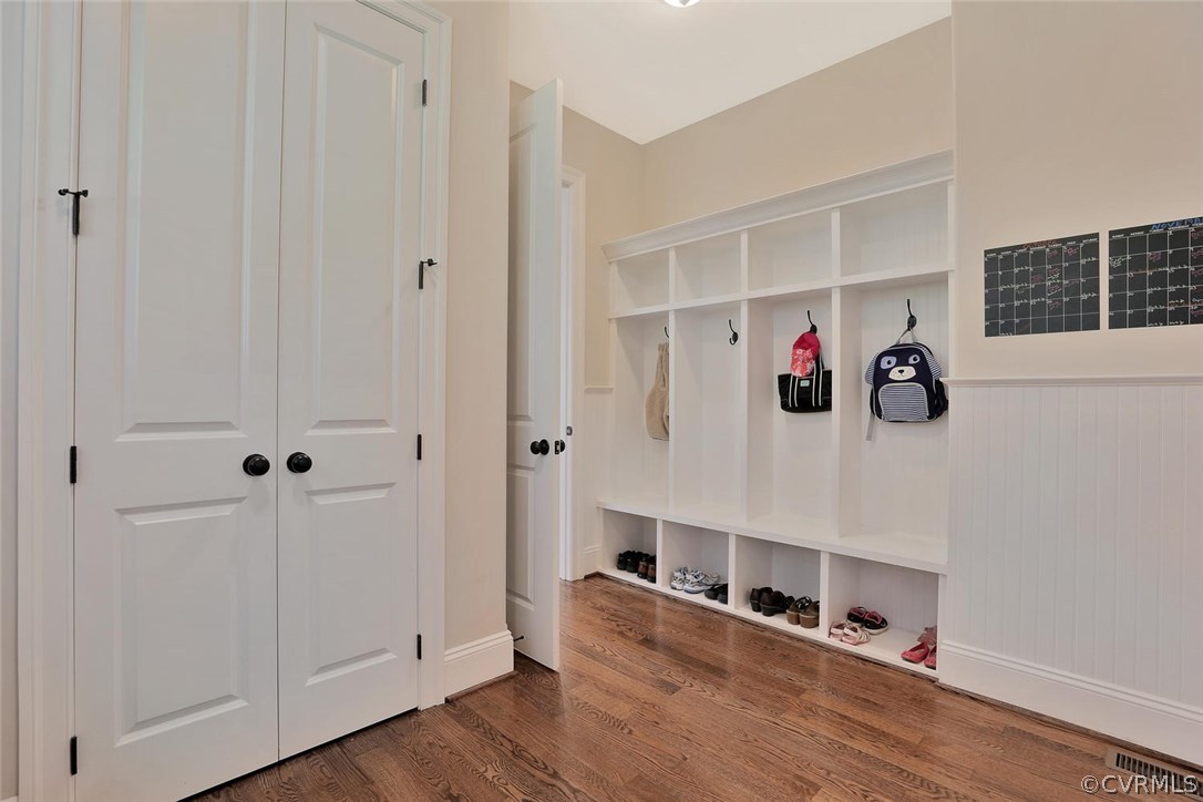 16106 Alsdell Road Midlothian, VA 23112 - Photo 19 of 46 a hallway with white cabinets and wooden floor