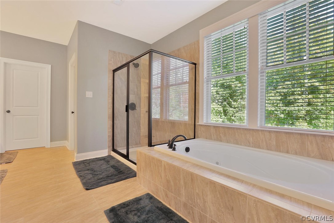 16106 Alsdell Road Midlothian, VA 23112 - Photo 30 of 46 a spacious bathroom with a bathtub and a shower