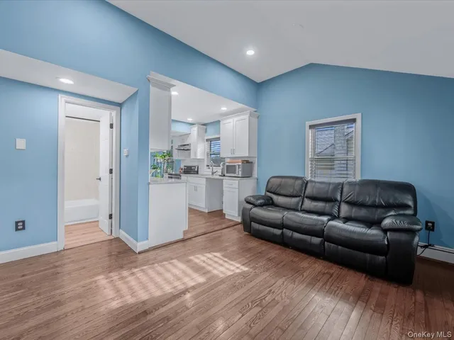 a living room with a couch and a wooden floor