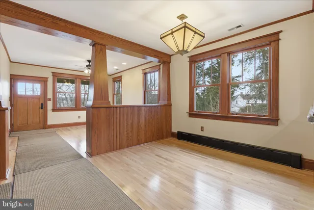 a view of a big room with wooden floor and windows